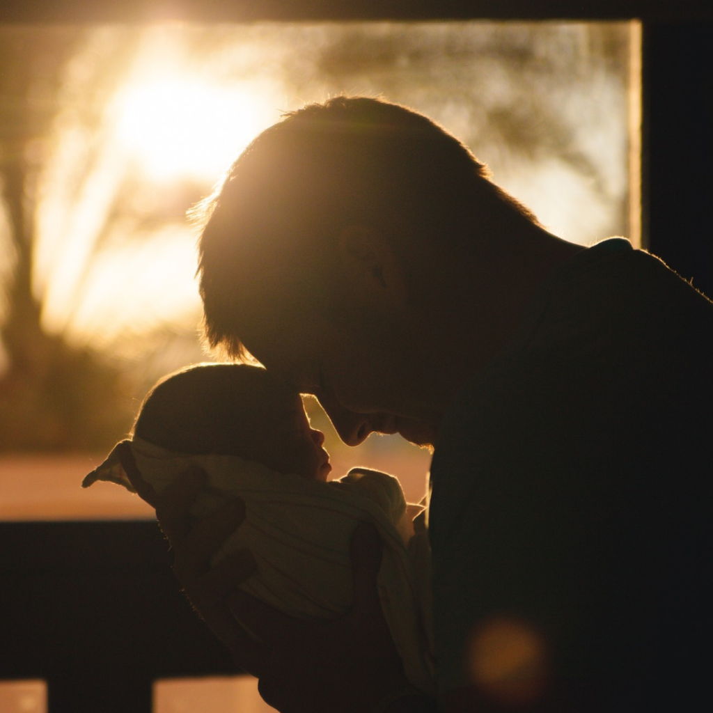 A man holding a baby in his arms.