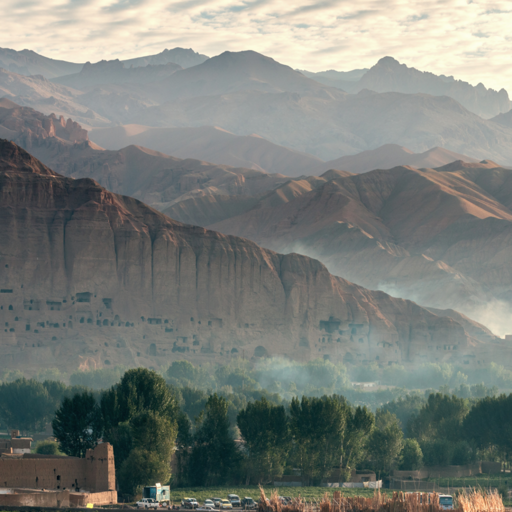 A mountain range with trees and buildings in the foreground.