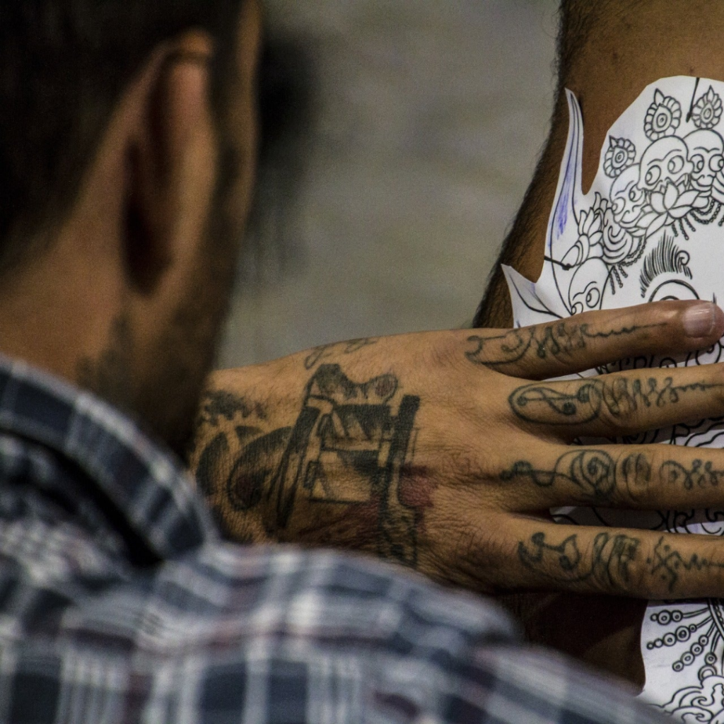 A man with tattoos on his arms and hands.